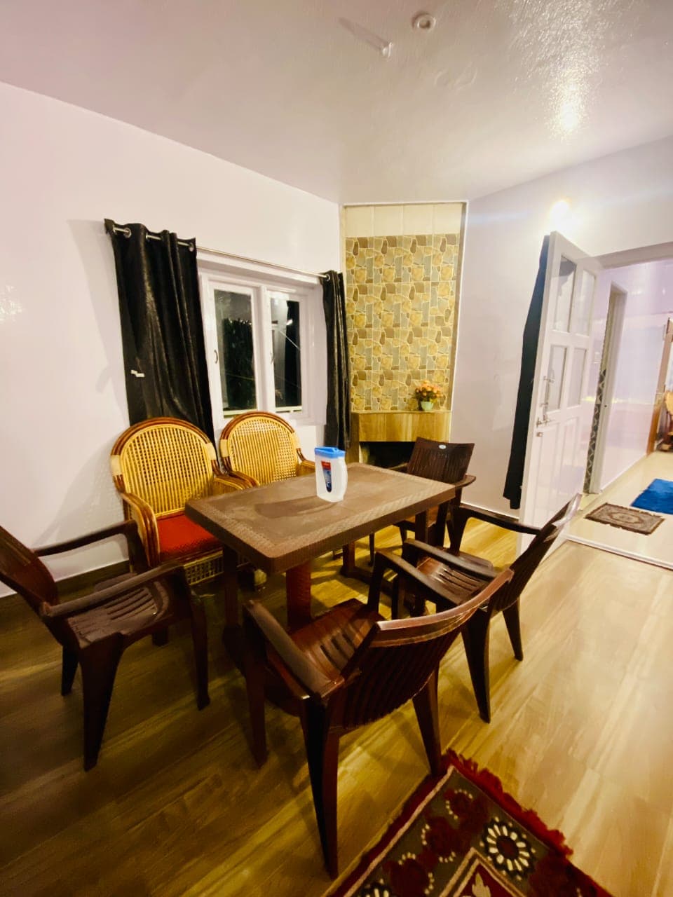 Glass House dining area with stone accent wall